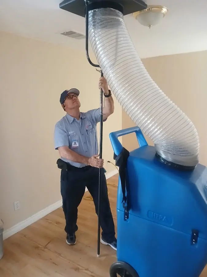 Furnace Tune-Up technician using HEPA equipment in Little Elm